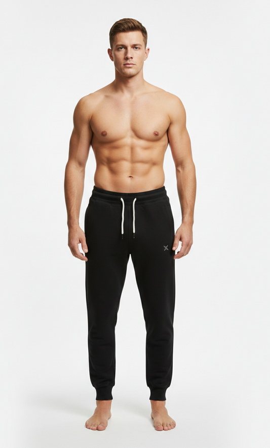 Male model wearing premium Black athletic joggers on white background front view