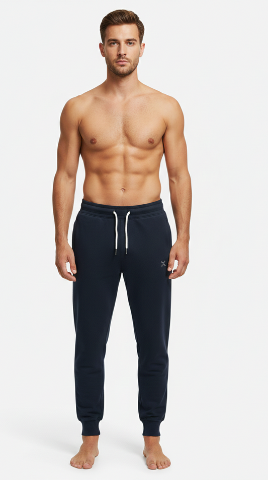 Male model wearing premium Navy Blue athletic joggers on white background front view