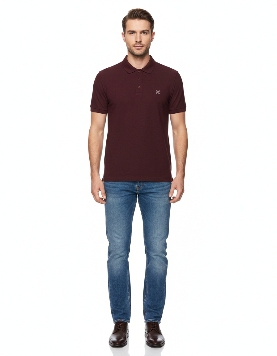 Man wearing a maroon polo shirt and blue jeans on a white background