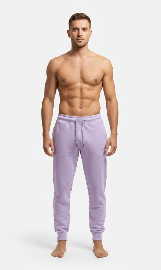 Male model wearing premium lavender athletic joggers on white background front view